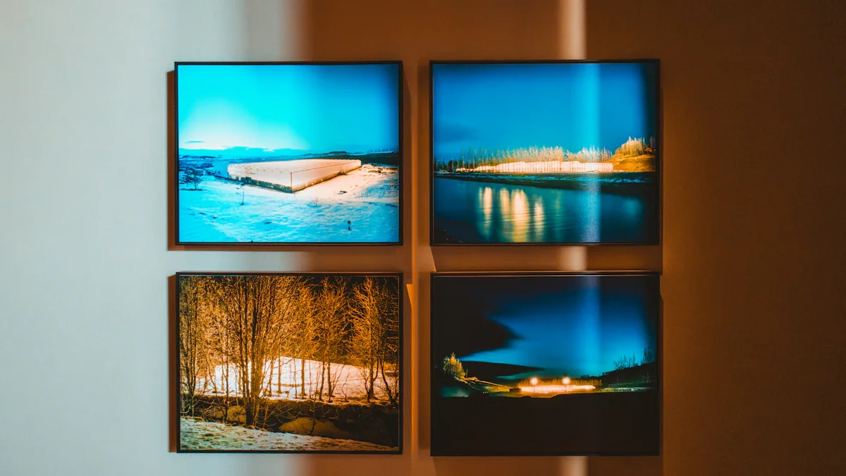 Four framed landscape photographs hanging on a gallery wall in soft lighting.