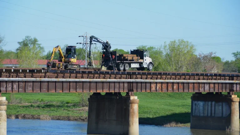 Construction machinery and a crane truck positioned on a bridge for essential repair work.