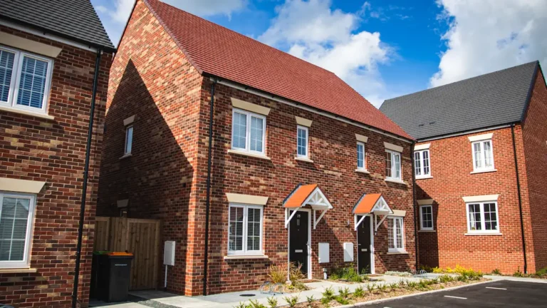 Modern brown brick terraced houses in a new residential housing estate in the UK.