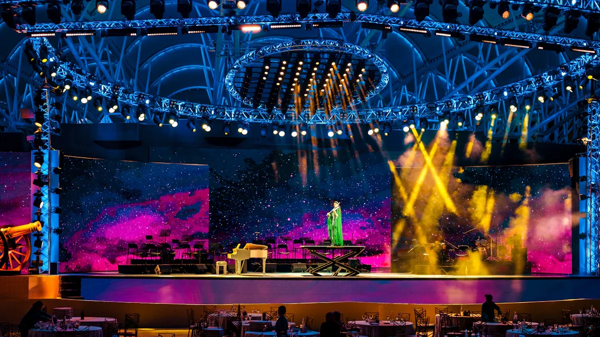 A grand gala stage illuminated with vibrant pink and blue lights during a live performance.