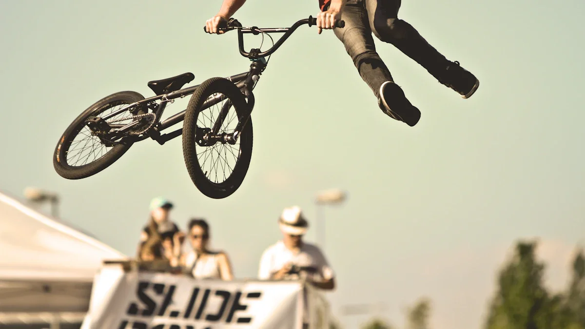A professional BMX rider performs a high-air trick against a clear sky during an outdoor urban sports festival.