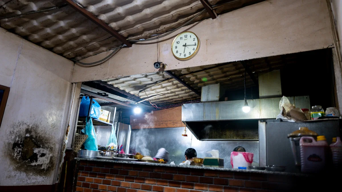 A dilapidated and unhygienic commercial kitchen with visible damp and mold on the walls.
