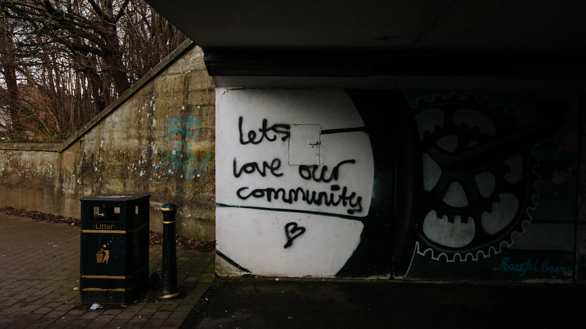 Graffiti on a wall reading 'lets love our community' with a heart symbol underneath.