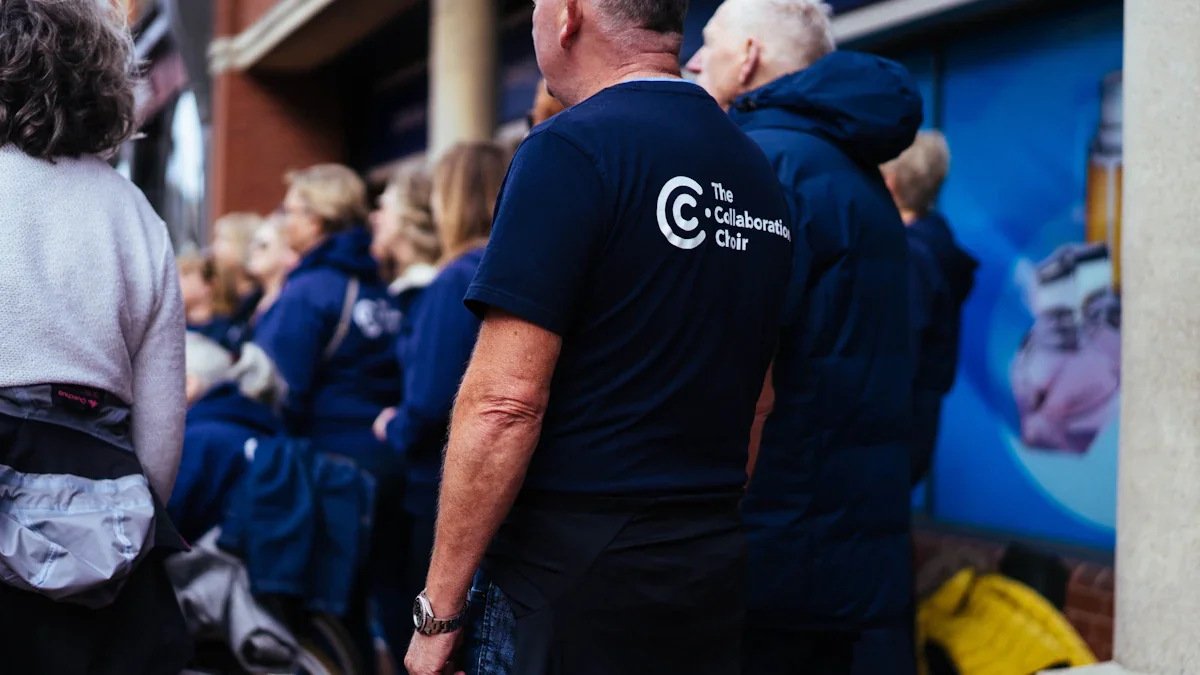 Group of volunteers in dark matching t-shirts standing together during a community event.