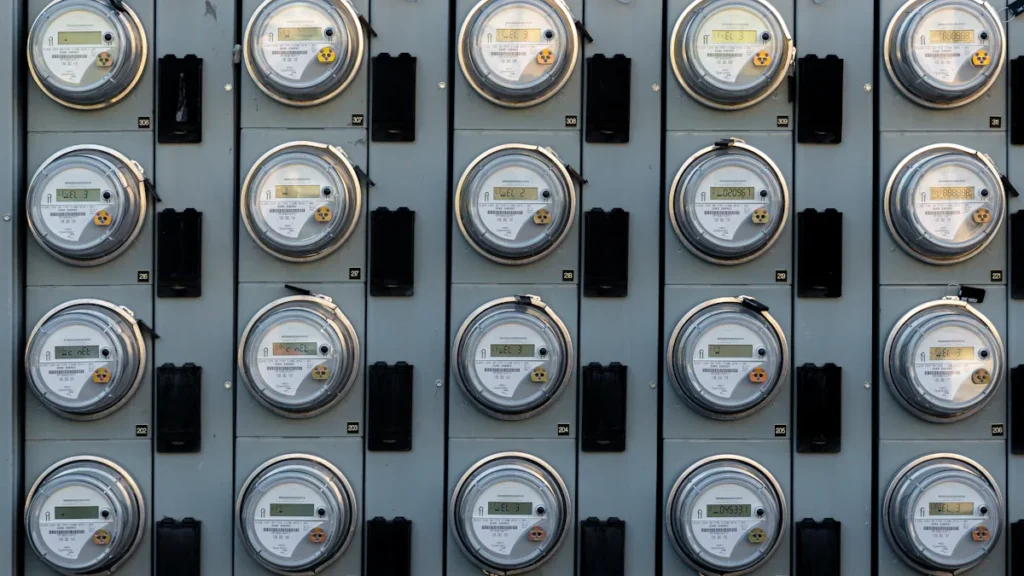Close-up of a human hand checking a residential gas meter reading.