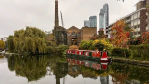A traditional narrowboat moored on Regents Canal in Islington, London, during the day.