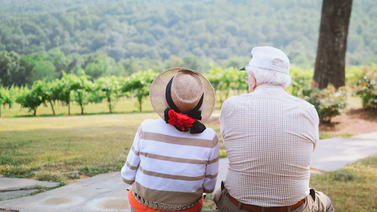 An elderly couple sitting together outdoors, representing the benefits of quality social care.