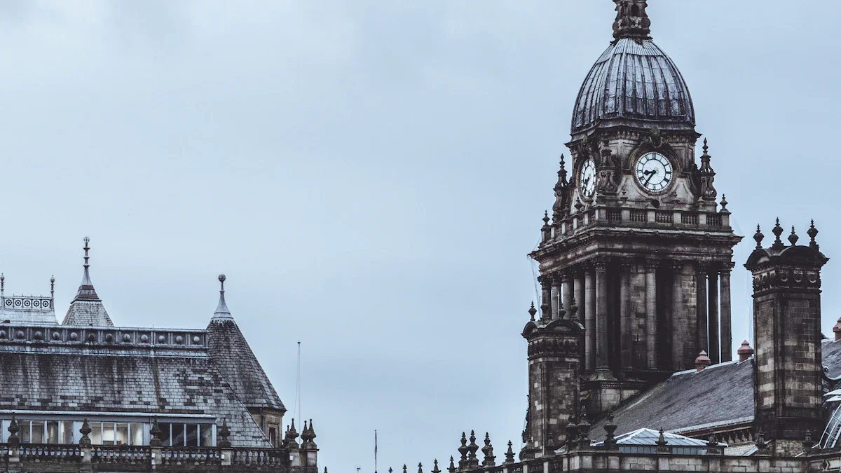 The grand pillars and clock tower of Leeds Town Hall with people walking on the street below.