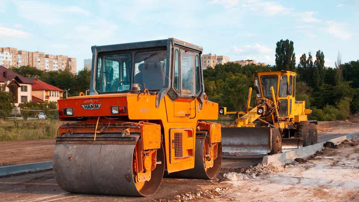 A heavy road roller and excavator working on a new asphalt road surface in a residential area.