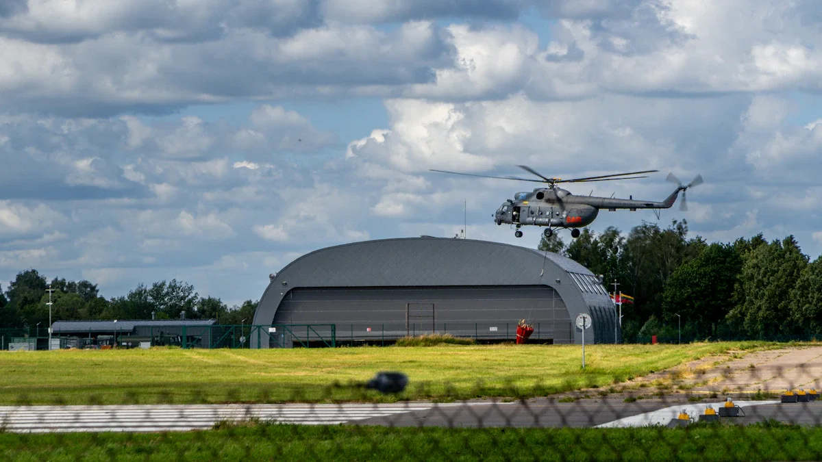 A military helicopter maneuvers near a hangar, representing the defense capabilities supported by Lithuania's €500m bond milestone.