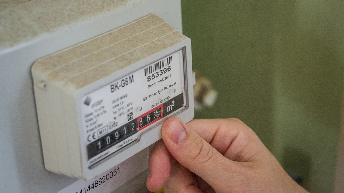 A person's hand touching a residential energy meter mounted on a wall inside a home.