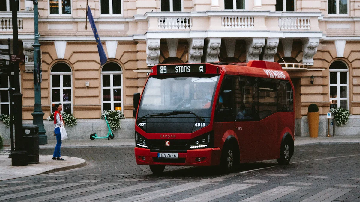 A modern red bus driving on a street in Vilnius, Lithuania, with historic buildings in the background.