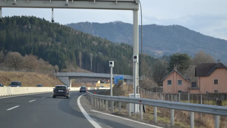 High-accuracy cameras and sensors mounted on a highway gantry over a multi-lane road.
