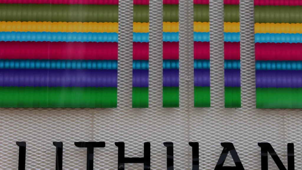 A close-up of a modern building facade featuring colorful patterns and the word LITHUAN in black letters.