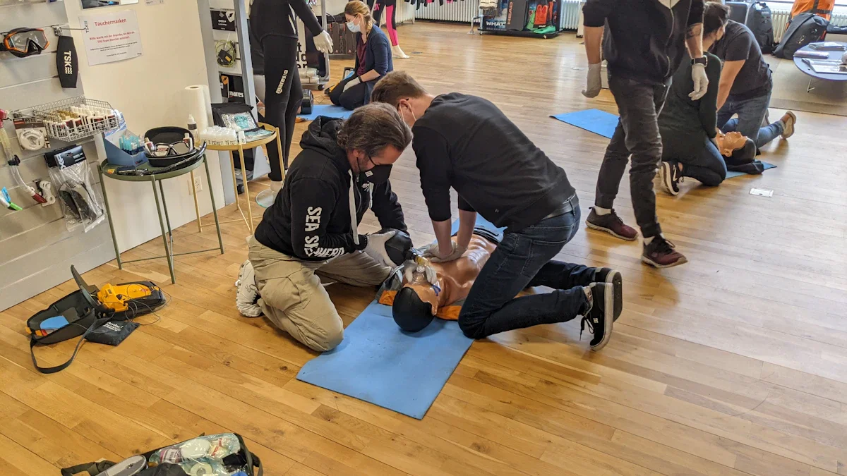Trainees practice CPR and emergency response techniques on medical manikins during a safety training session.