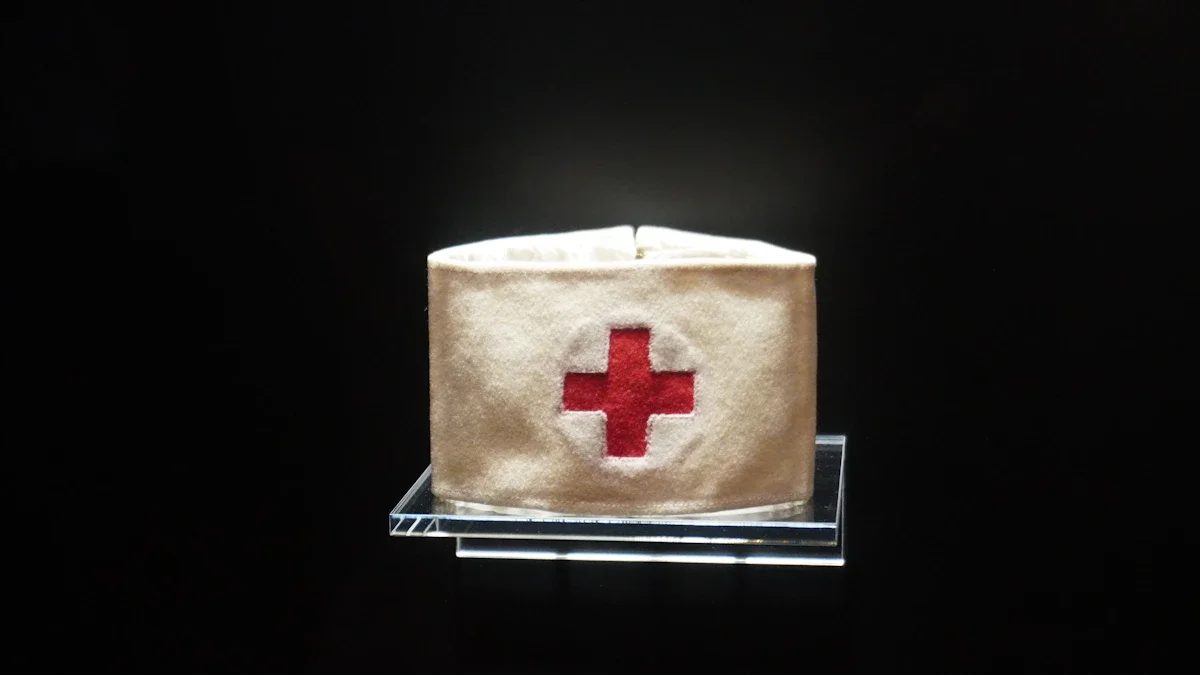 A vintage white fabric armband with a stitched red cross emblem displayed on a transparent stand.