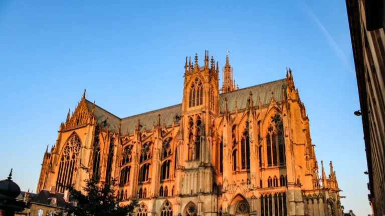 The Gothic Saint-Étienne Cathedral of Metz glowing in the warm light of a golden sunset.