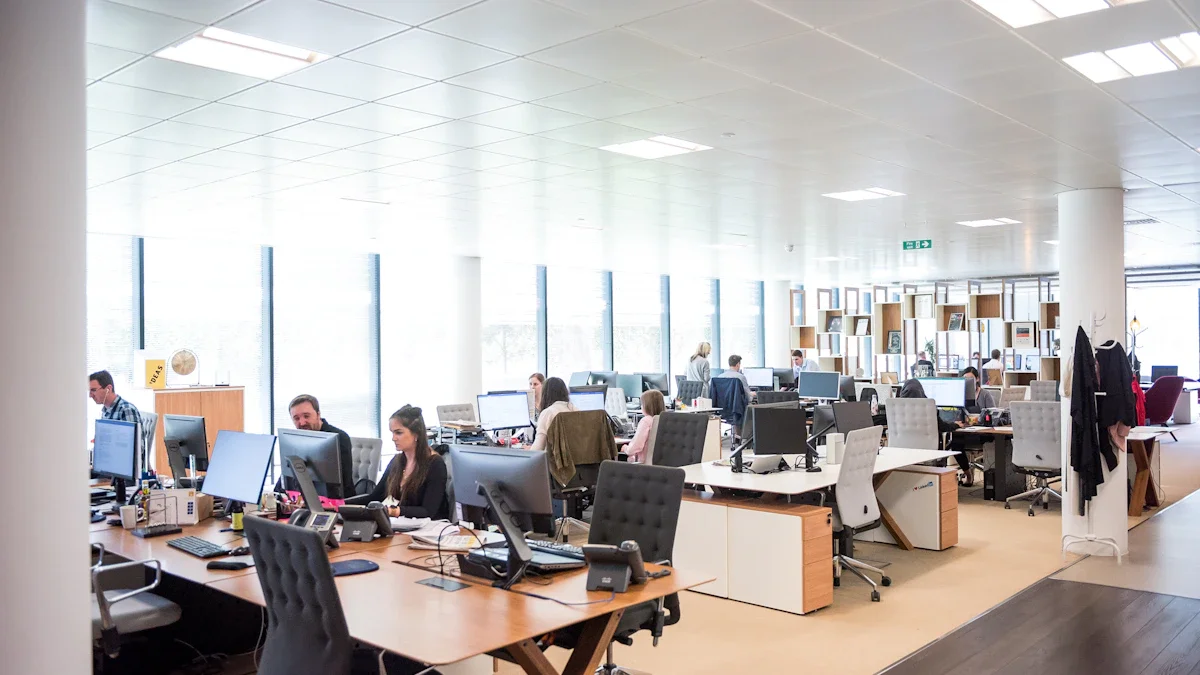 A wide, bright professional office space in the UK with staff working at various desk stations.