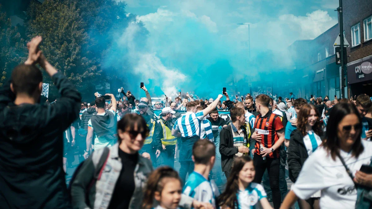 Football fans in blue and white jerseys cheering during a street celebration with smoke.