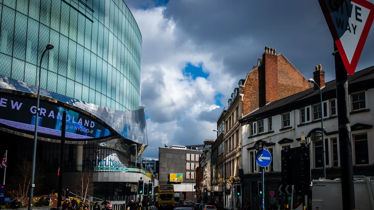 A view of Nottingham city centre featuring the modern curved glass facade of the Victoria Centre alongside traditional brick architecture under a dramatic sky.