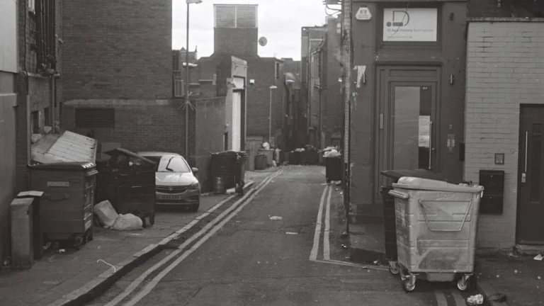 A black and white street view in Nottingham, England, capturing a local urban atmosphere.