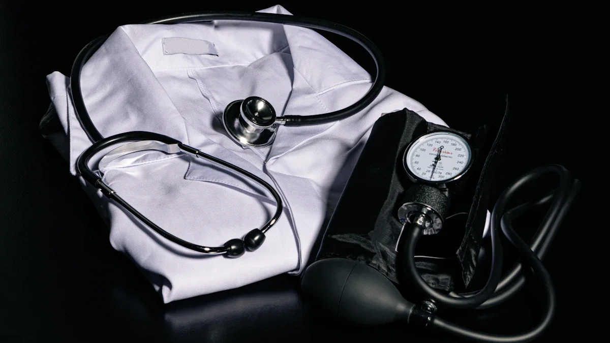 A black stethoscope and blood pressure monitor resting on a folded white medical doctor's coat.