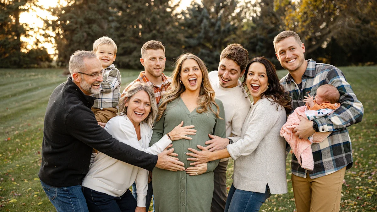 A large, multi-generational family group smiling and embracing together in an outdoor park setting.