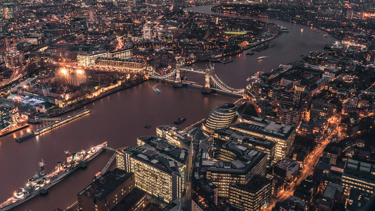An expansive aerial view of a UK city skyline at dawn, featuring a river and bridges.