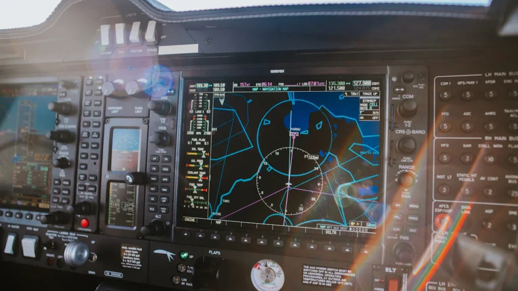 A close-up of a modern aircraft's cockpit displays and flight instrumentation panels with digital readouts.