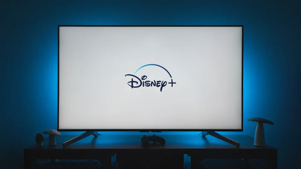 A flat screen television displaying the Disney Plus streaming service logo at home.