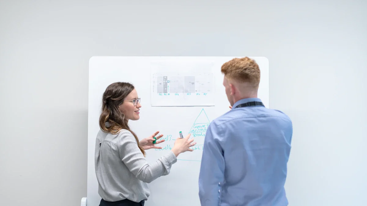 Two colleagues discussing development plans on a whiteboard in a professional office setting.