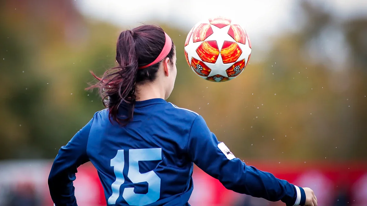 Young female soccer player controlling a ball during a professional training session