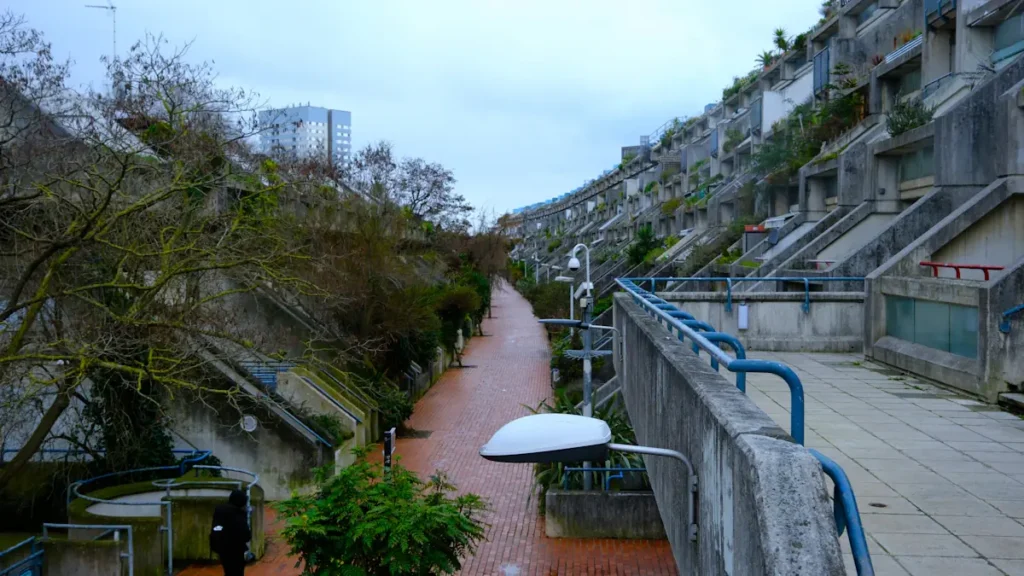 A person walking through a British residential housing estate after the rain.