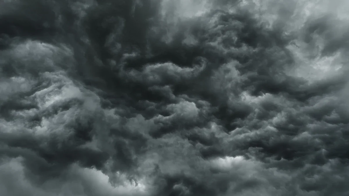 Ominous gray storm clouds gathering above a residential area before heavy rain.