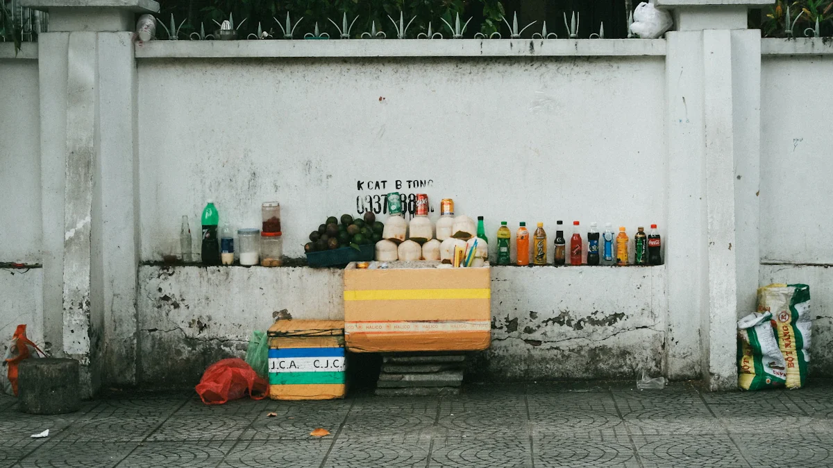 Row of various glass bottles displayed on a ledge against a concrete wall.