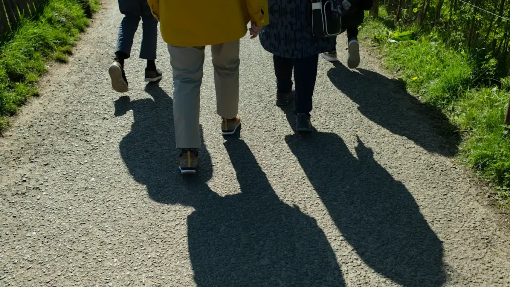 People walking on a gravel path, ideal for a story on walking meetings.